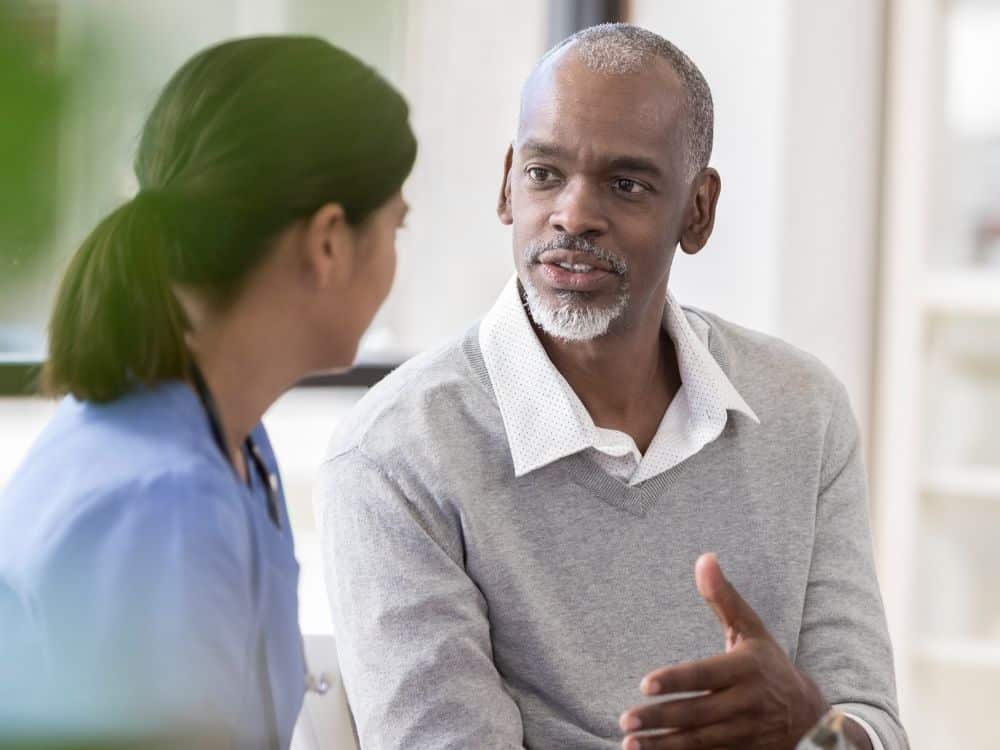 mature man talking to a healthcare professional